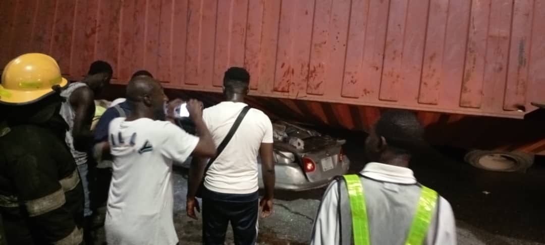 Three cheat death as container crushes car in Lagos Three cheat death as container crushes car in Lagos
